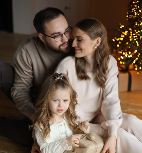 Parents Kissing Baby